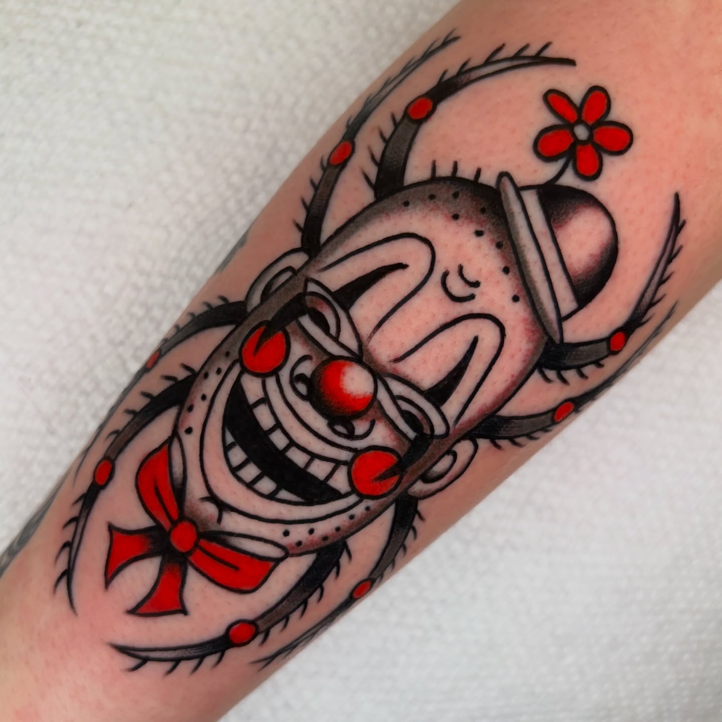 Clown beetle American traditional tattoo on the forearm by rachael