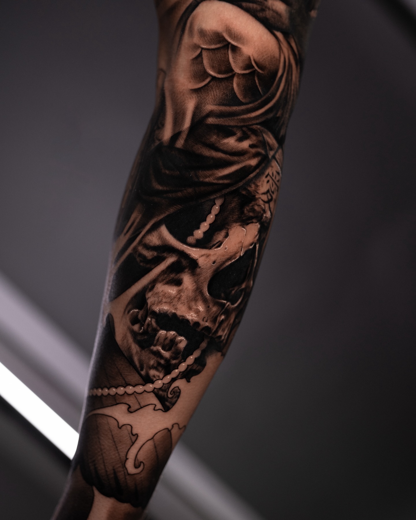 Skull with chain realism tattoo on the forearm by Tattoo Artist