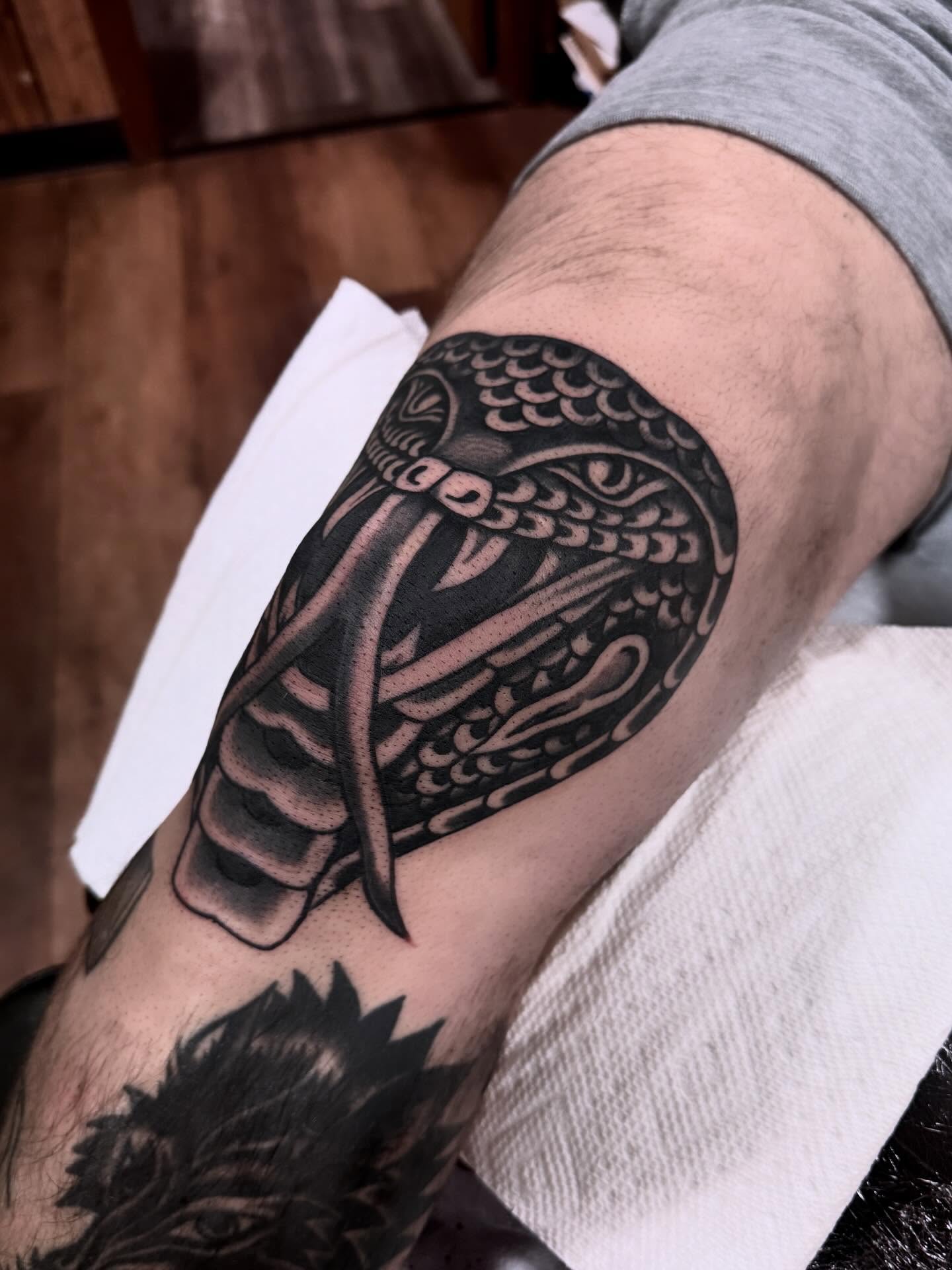 Snake black and grey tattoo on the forearm by Ryan Engels