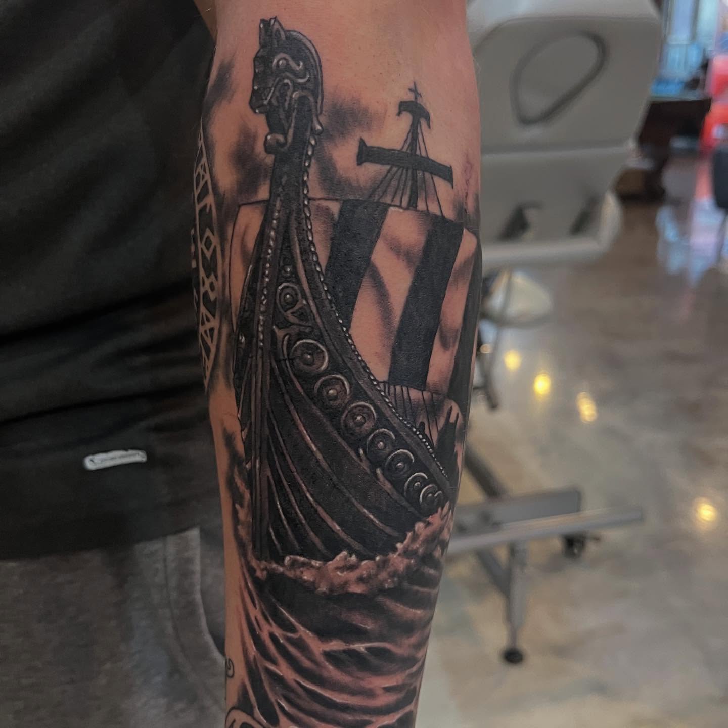 Viking ship realism tattoo on the forearm by Tyler Howard
