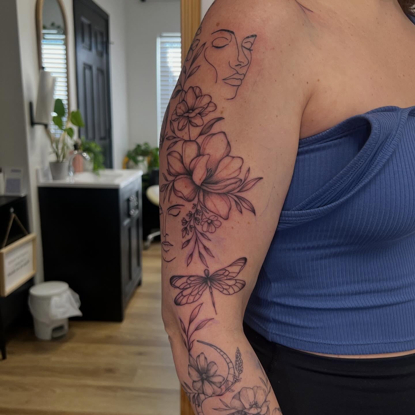 Floral and dragonfly realism tattoo on the upper arm by Presley Tattoos, Murfreesboro, Tennessee