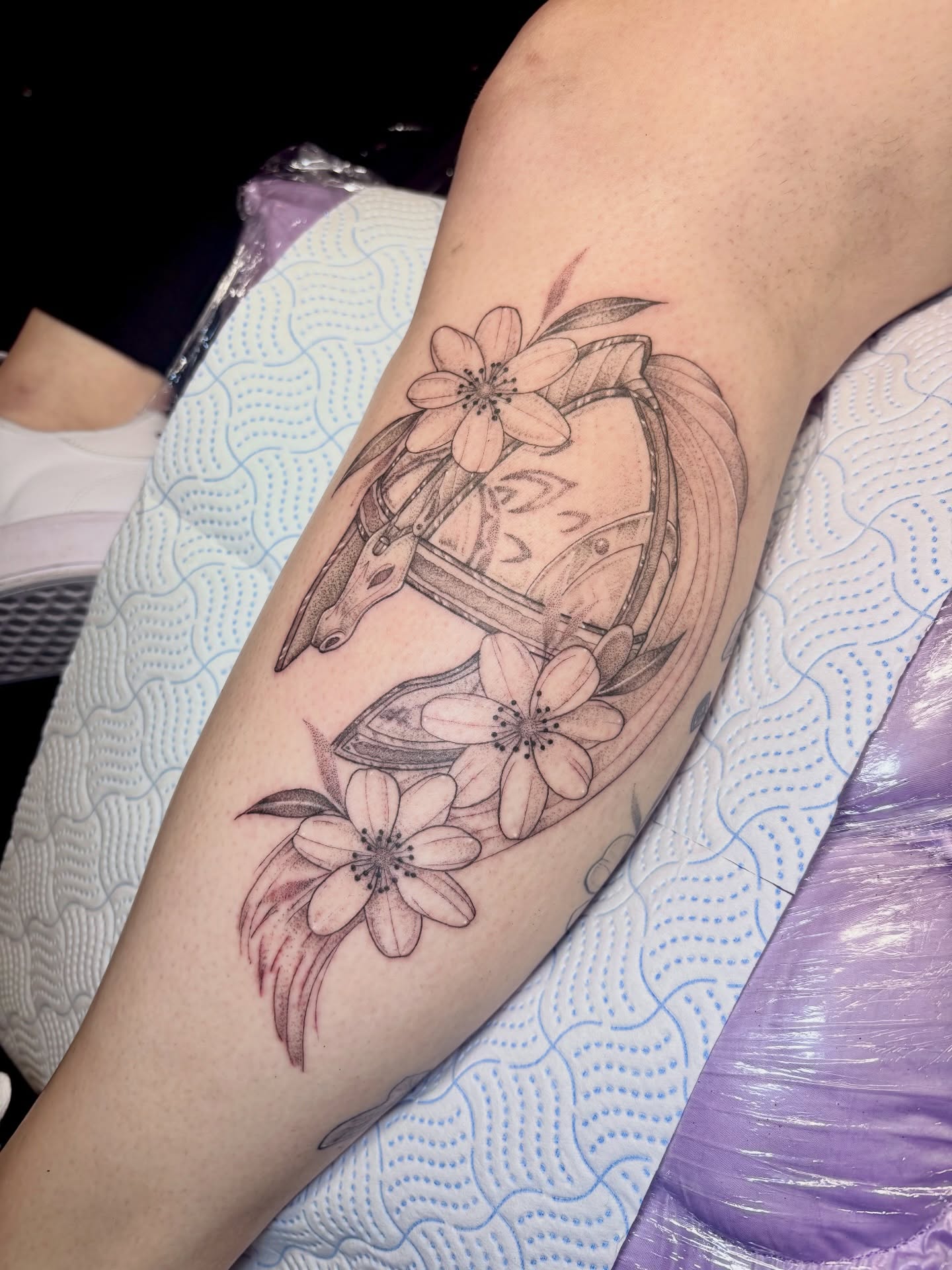 Cherry blossoms and anchor black and grey tattoo on the forearm by Charlotte Brown, Leeds, England