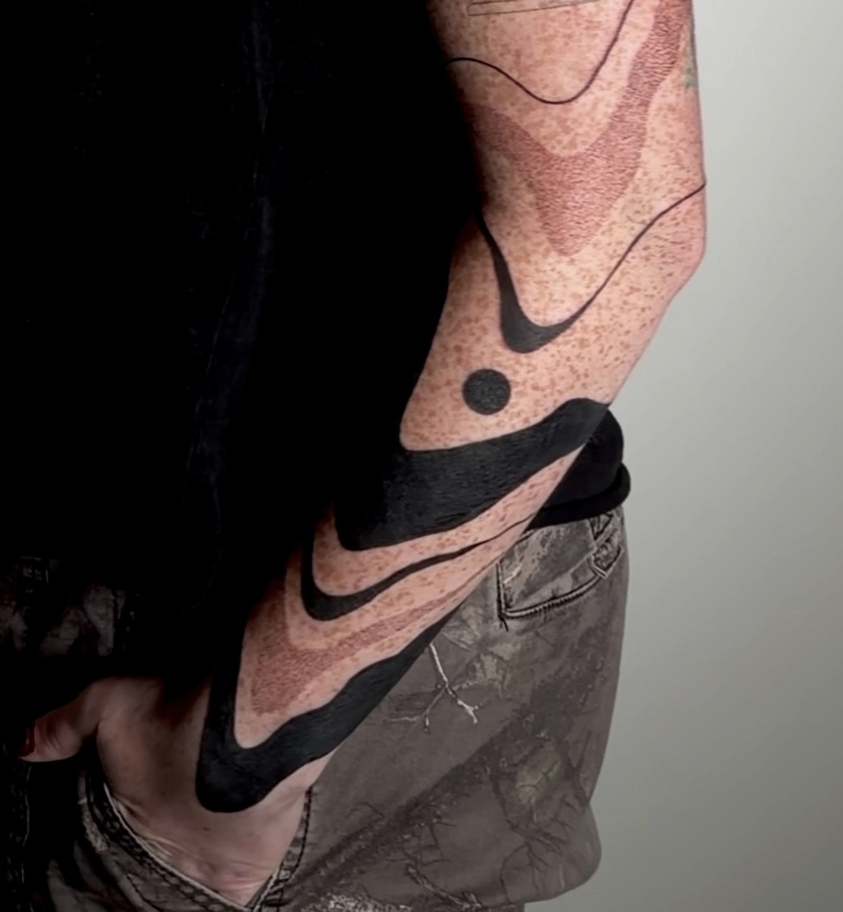 Nike swoosh black and grey tattoo on the forearm by Rachel