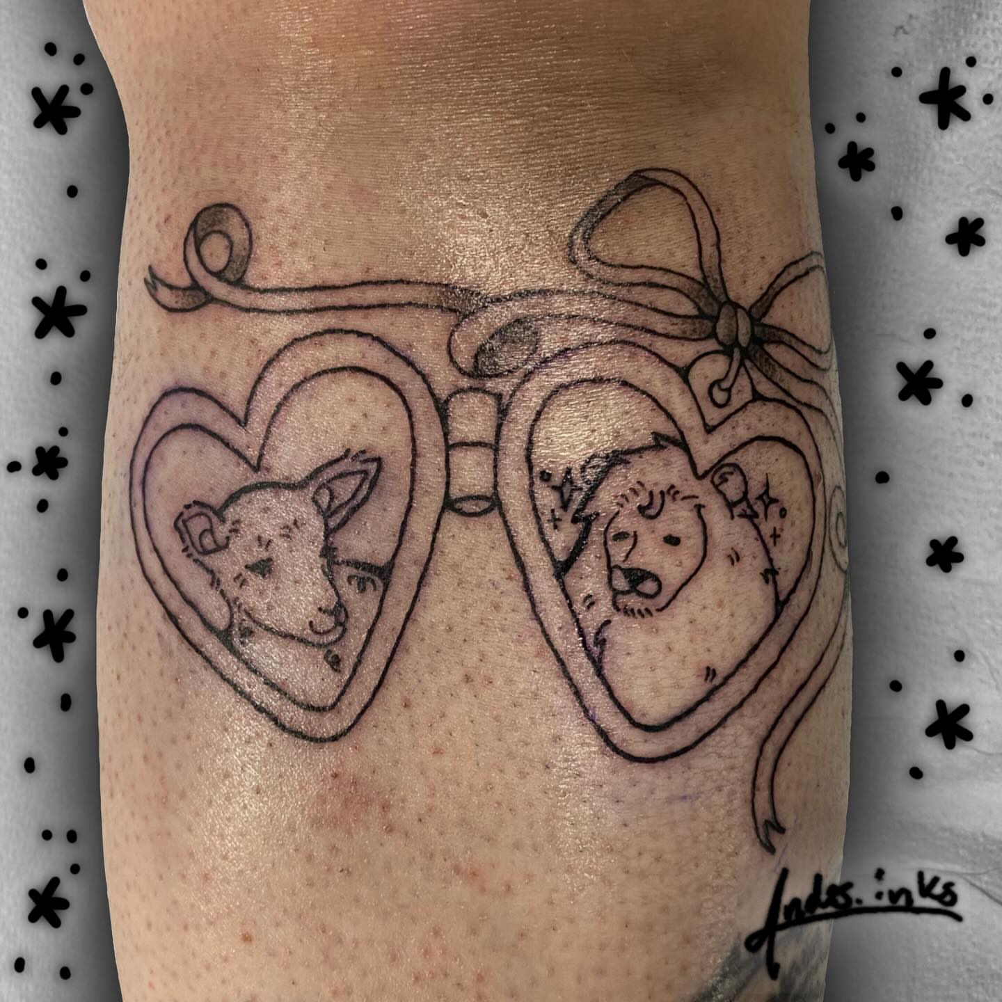 Heart-shaped binoculars black and grey tattoo on the forearm by ande