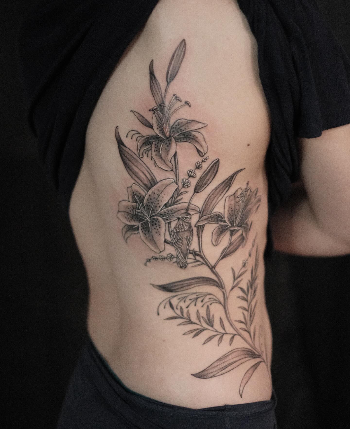 Lilies and bird realism tattoo on the ribs by Isabelle Kellar, San Diego, California
