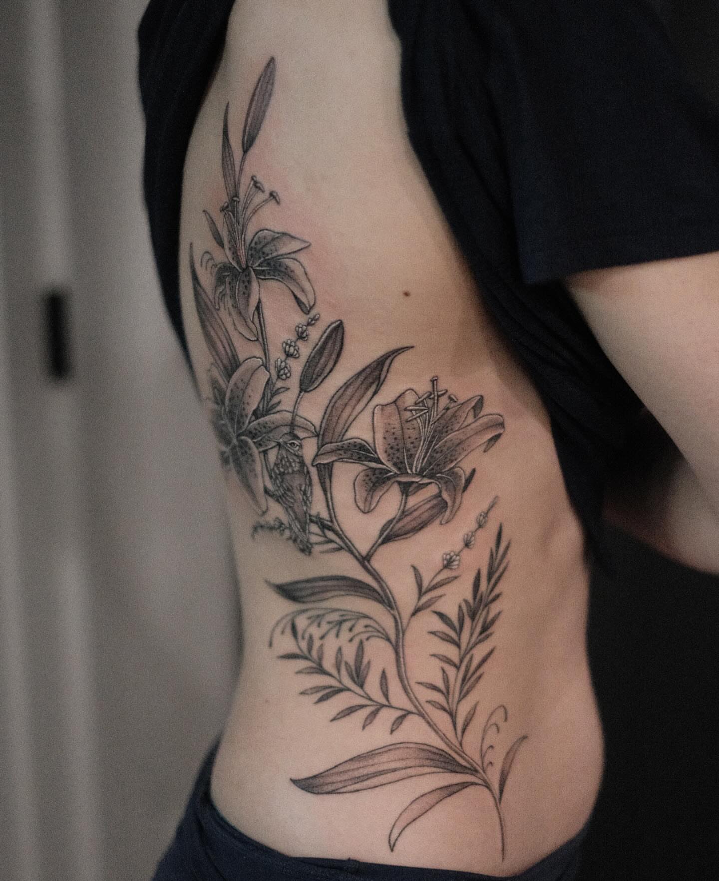 Lily flowers black and grey tattoo on the ribs by Isabelle Kellar, San Diego, California
