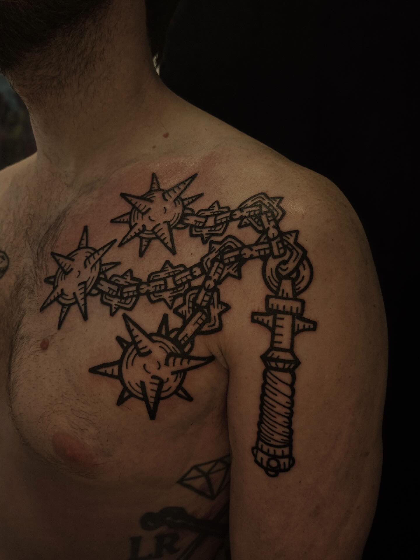 Chain and stars black and grey tattoo on the chest by ashley blyght