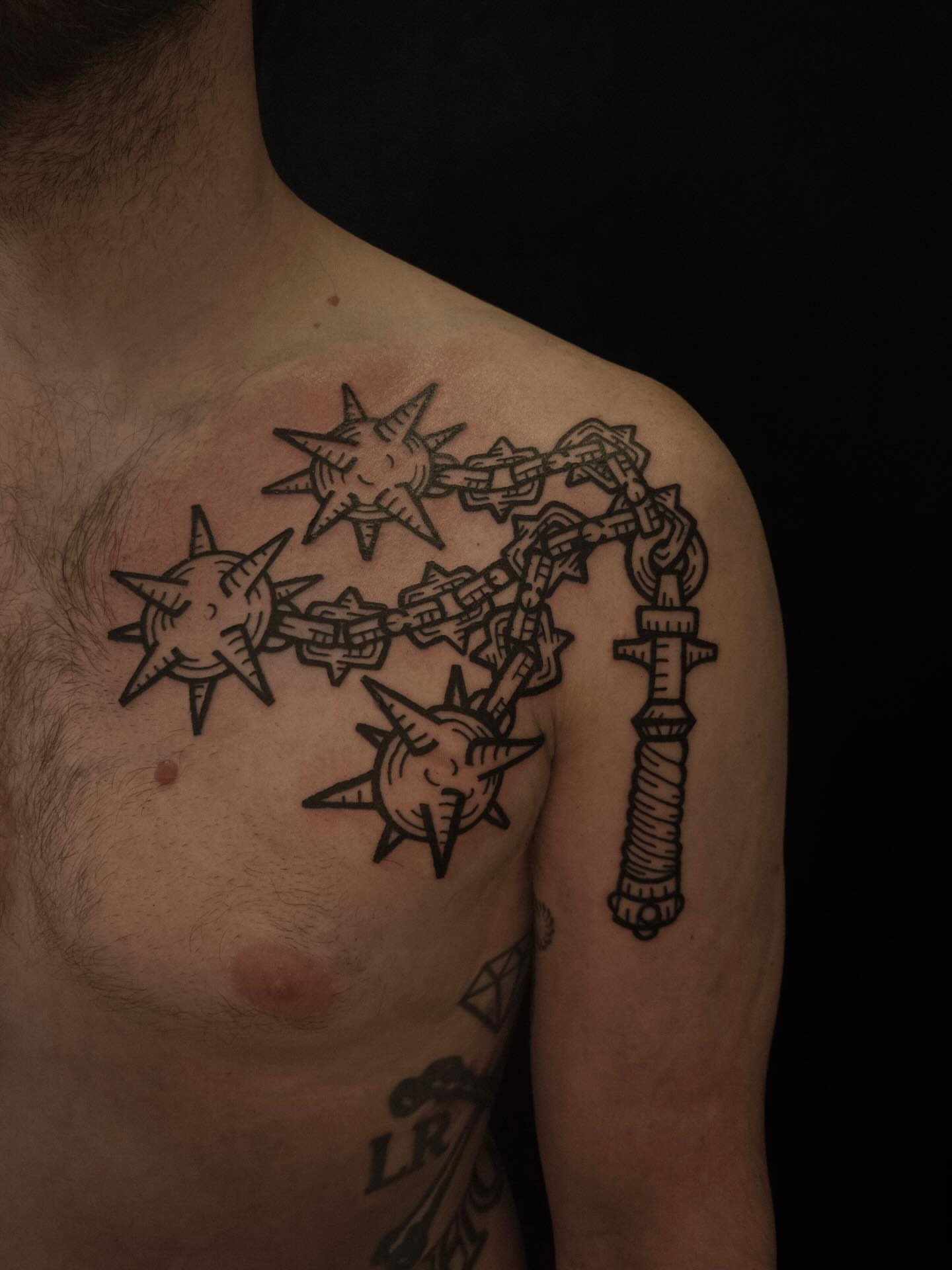 Chain and stars black and grey tattoo on the chest by ashley blyght