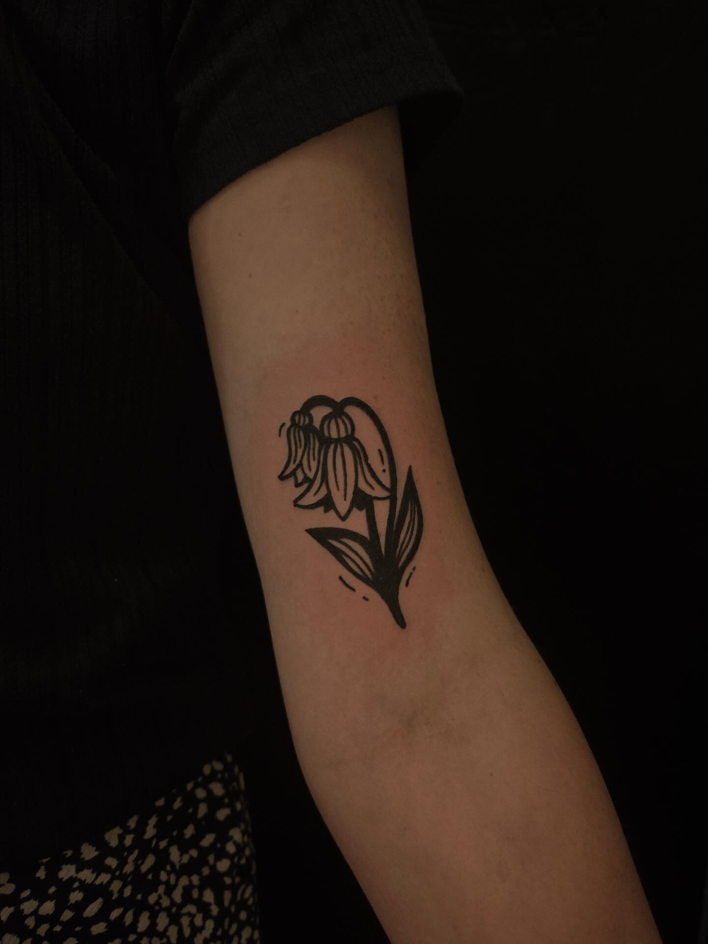 Bellflower black and grey tattoo on the forearm by ashley blyght