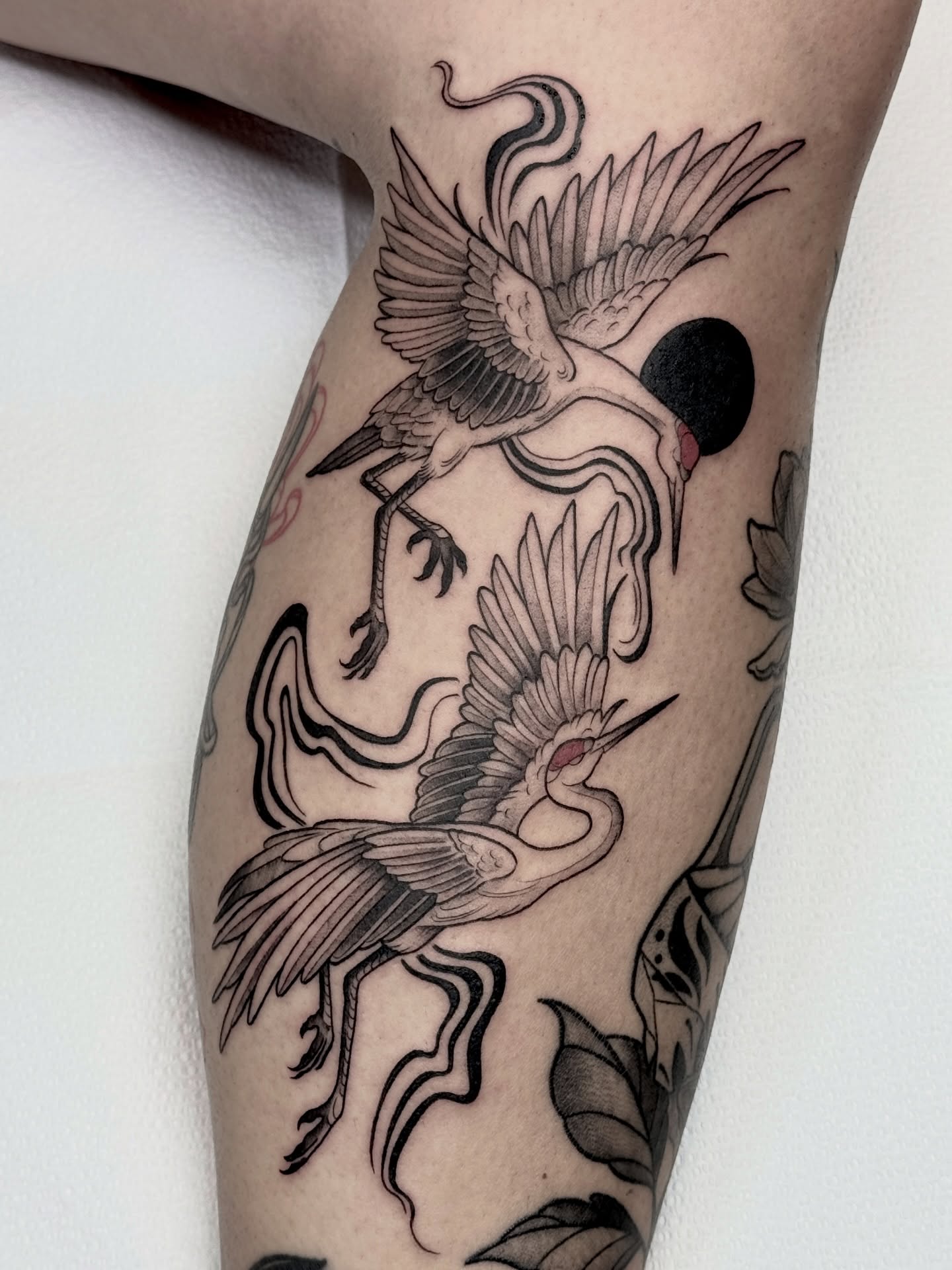 Cranes and moon black and grey tattoo on the forearm by Hannah May, La Mesa, California