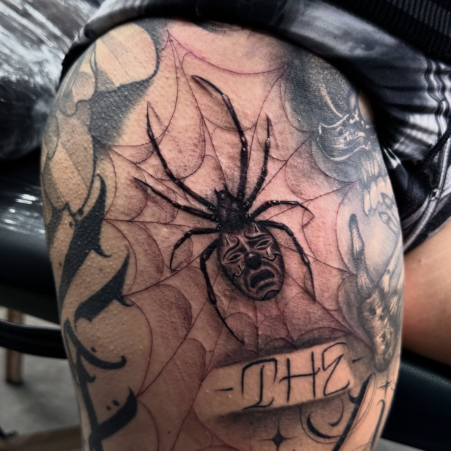 Spider and mask realism tattoo on the forearm by Joey Moreno