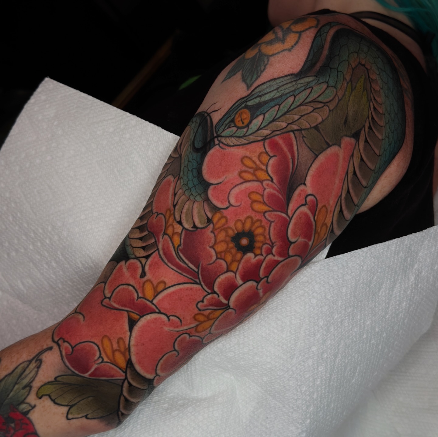 Snake and peony japanese irezumi tattoo on the forearm by Golden Heart Tattoo Co