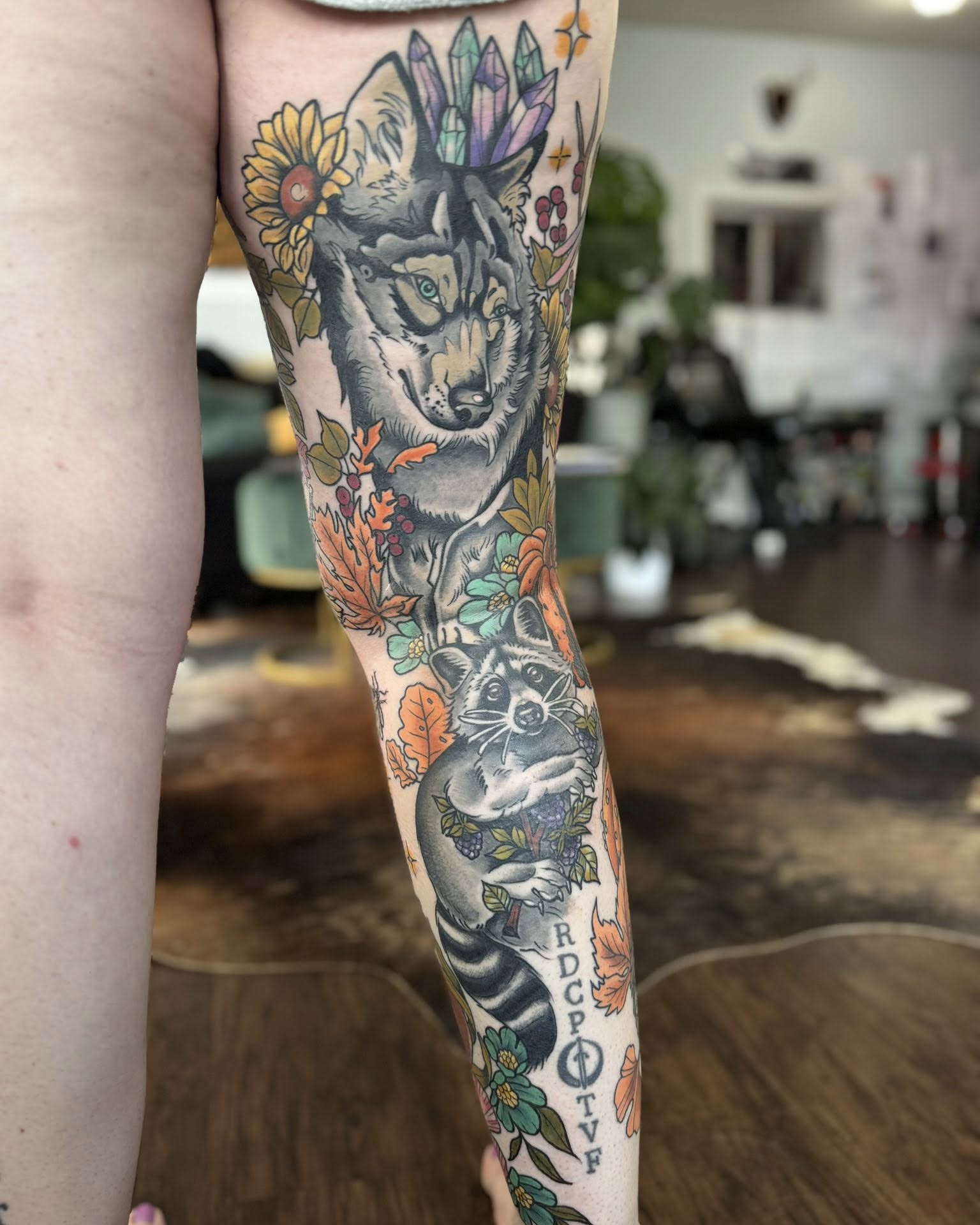 Wolf and raccoon realism tattoo on the forearm by Eden Rose, Kalama, Washington