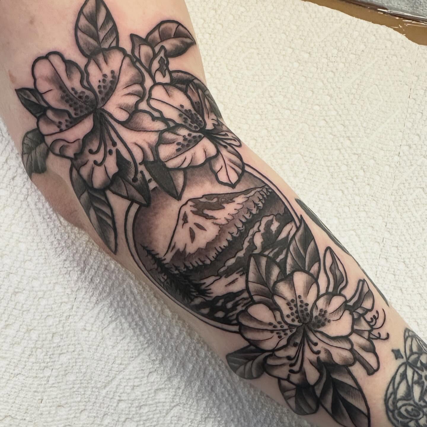 Floral bouquet black and grey tattoo on the forearm by Katie Beth