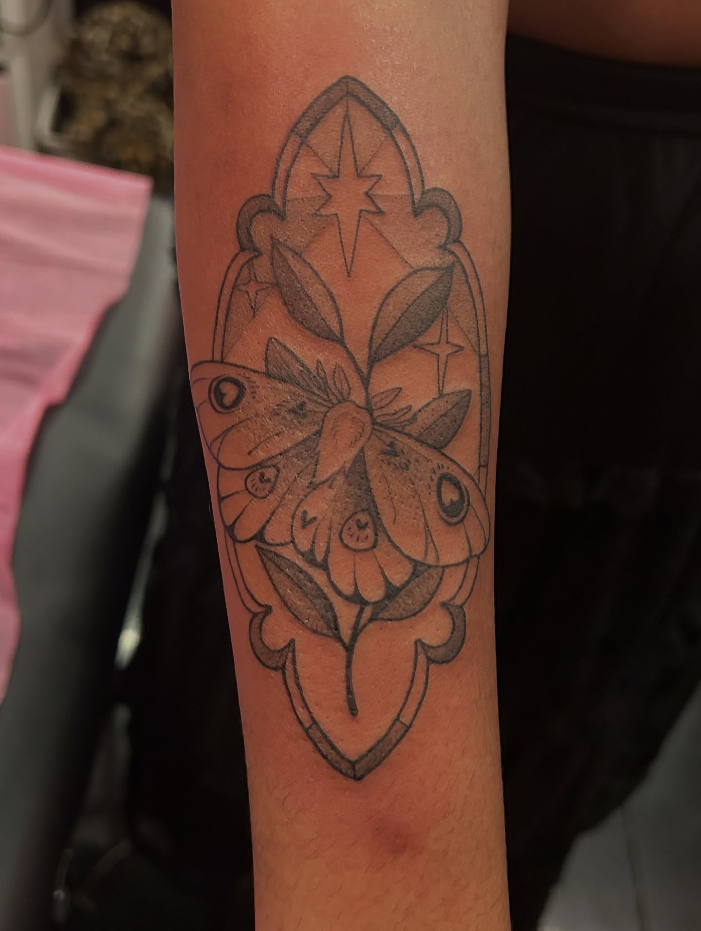Moth and floral black and grey tattoo on the forearm by Summer Balcom M.