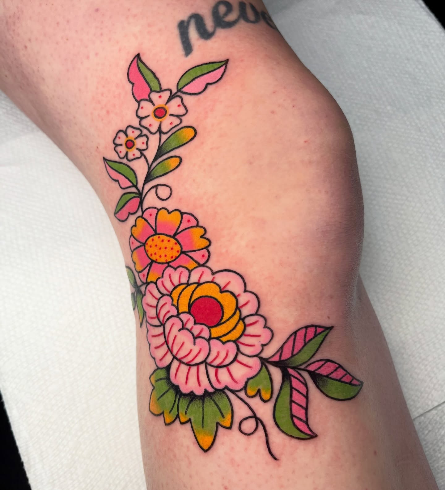 Floral bouquet American traditional tattoo on the forearm by Alena McDonald