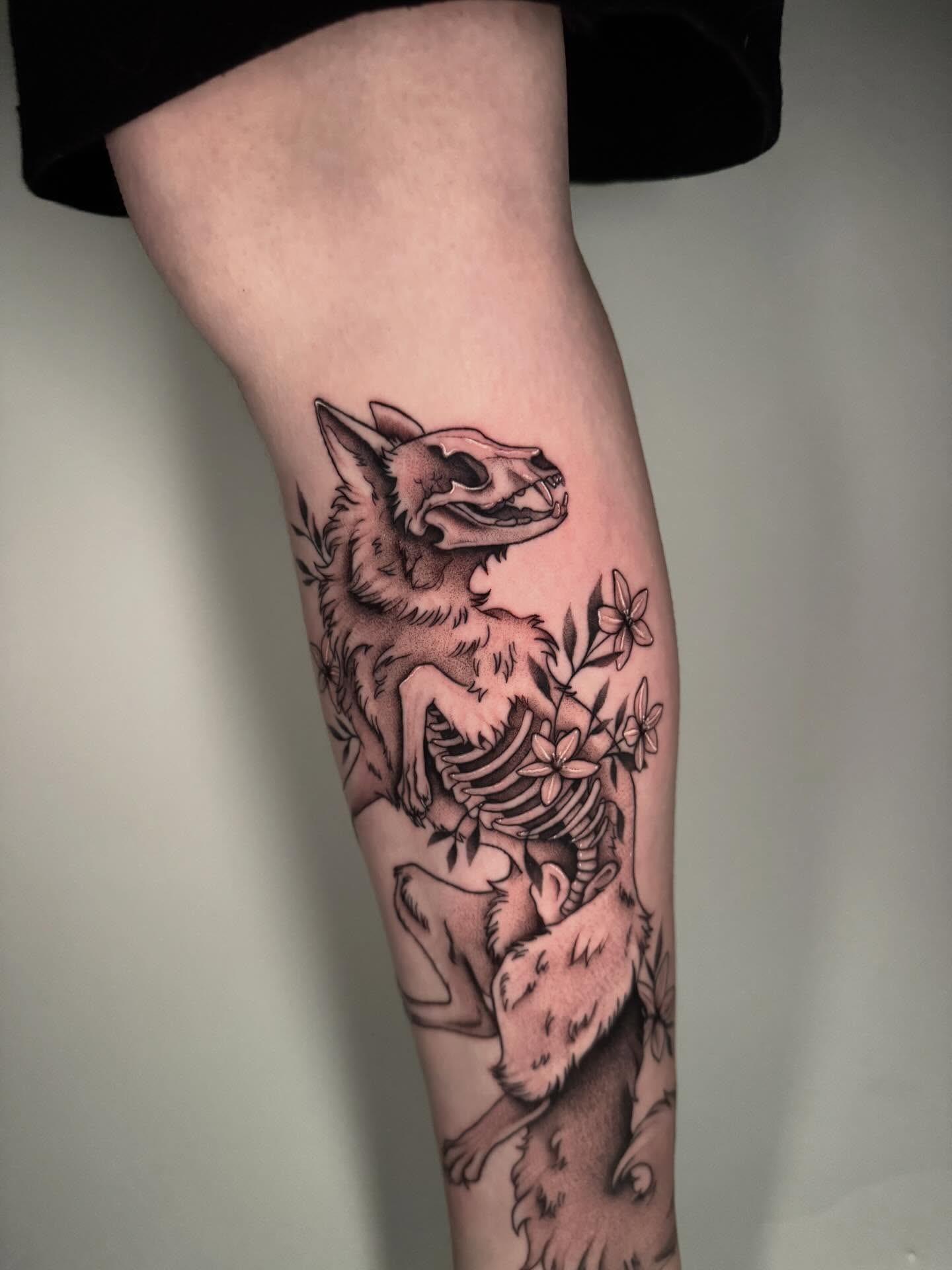 Wolf skeleton with flowers realism tattoo on the forearm by kelsey hackett
