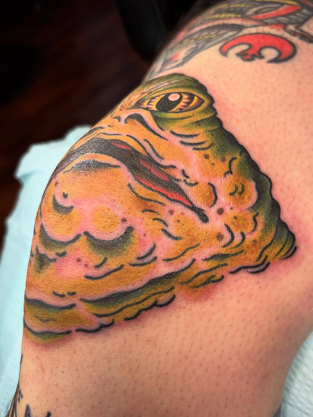 Jabba the Hutt American traditional tattoo on the upper arm by Tom Wenzell