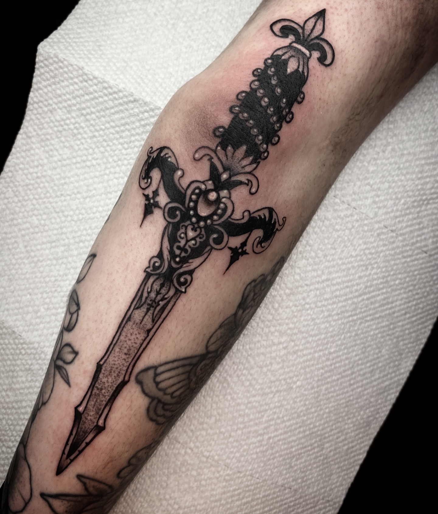 Sword black and grey tattoo on the forearm by Randi Frey