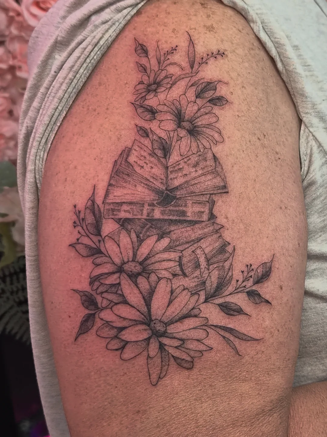Book and flowers black and grey tattoo on the shoulder by 𝒱𝒽𝓎𝓍𝒾𝓃