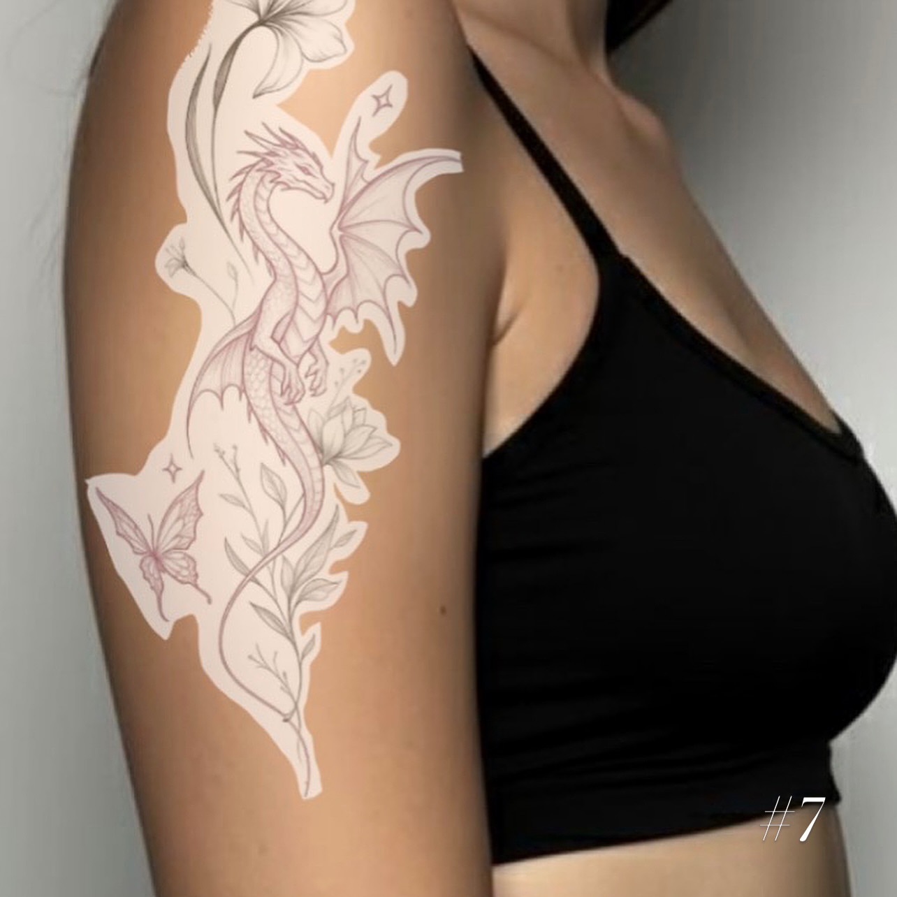 Dragon and floral fine line tattoo on the upper arm by @tattoosbyskyeee
