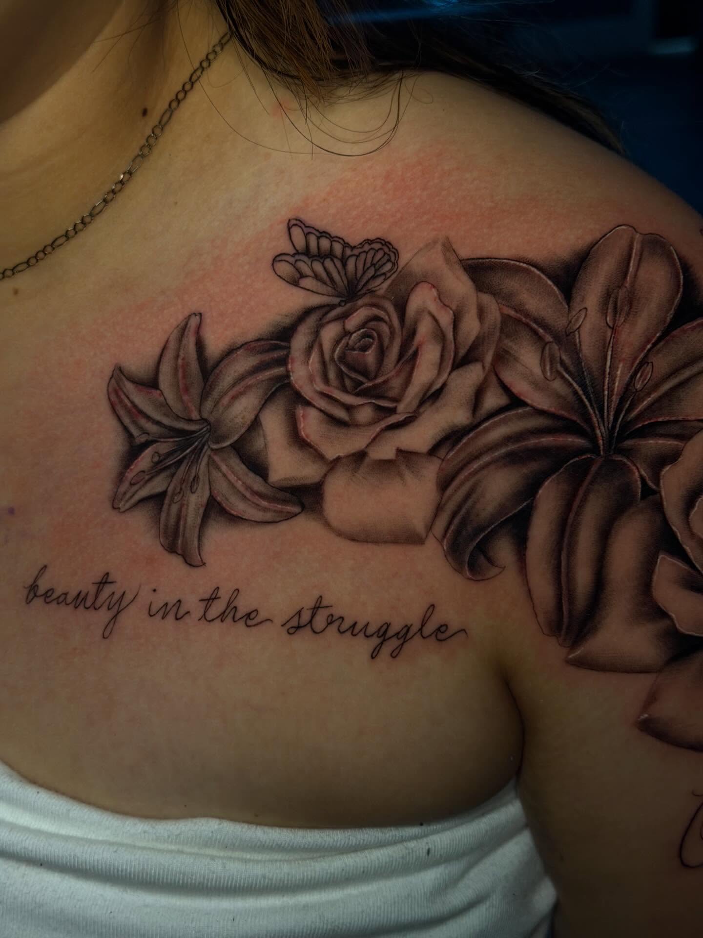 Flowers and butterfly realism tattoo on the shoulder by Dany
