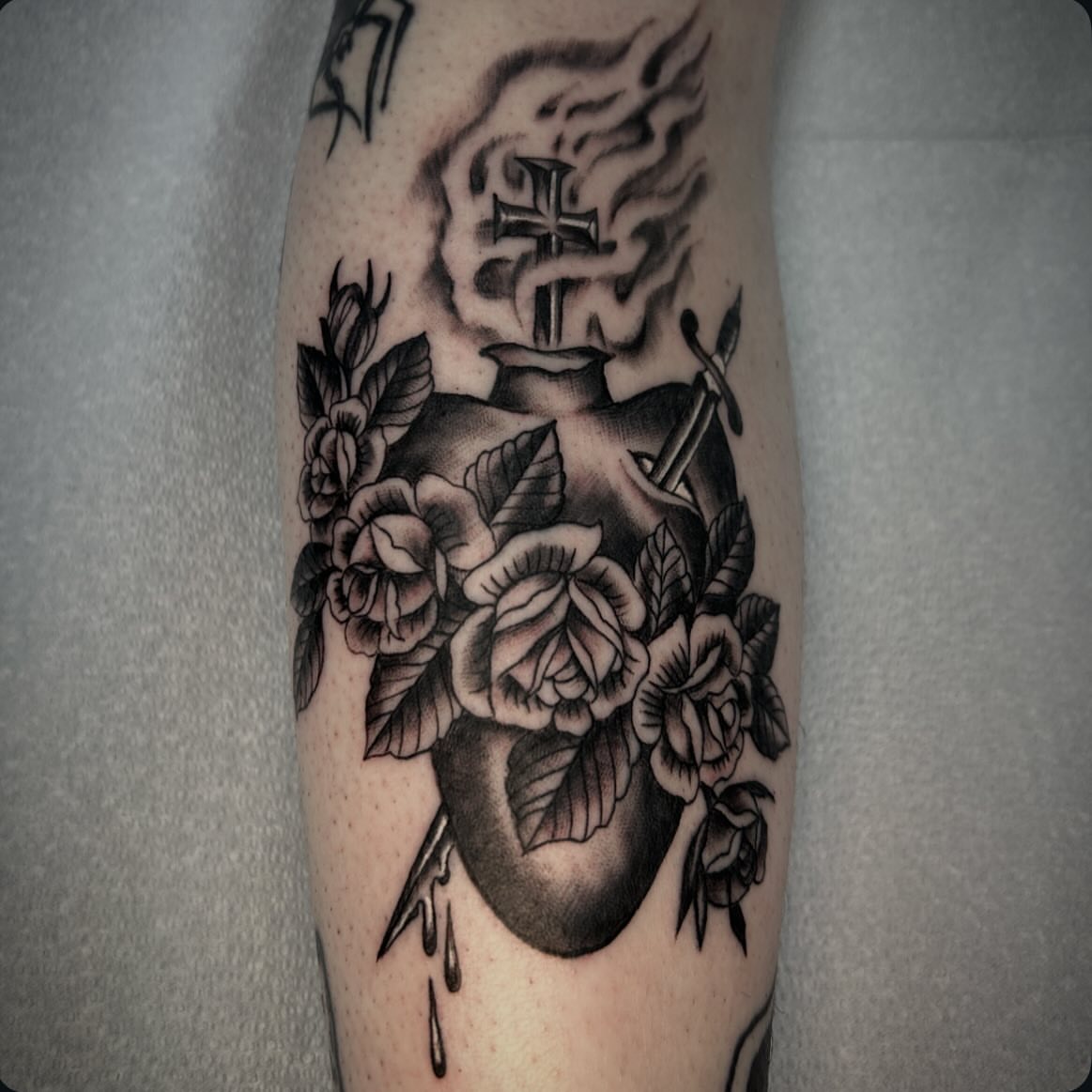 Heart with roses black and grey tattoo on the forearm by Dylan O'Quin