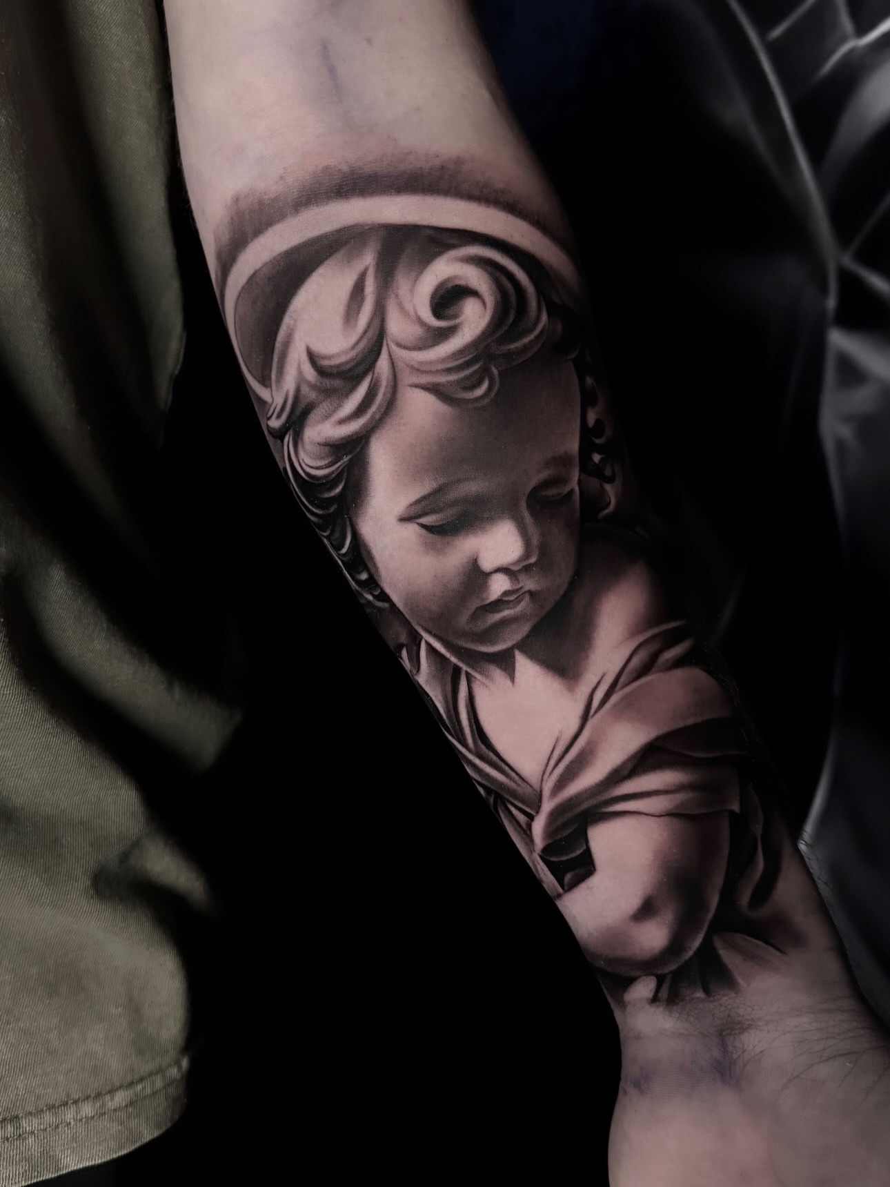 Child realism tattoo on the forearm by Yudel