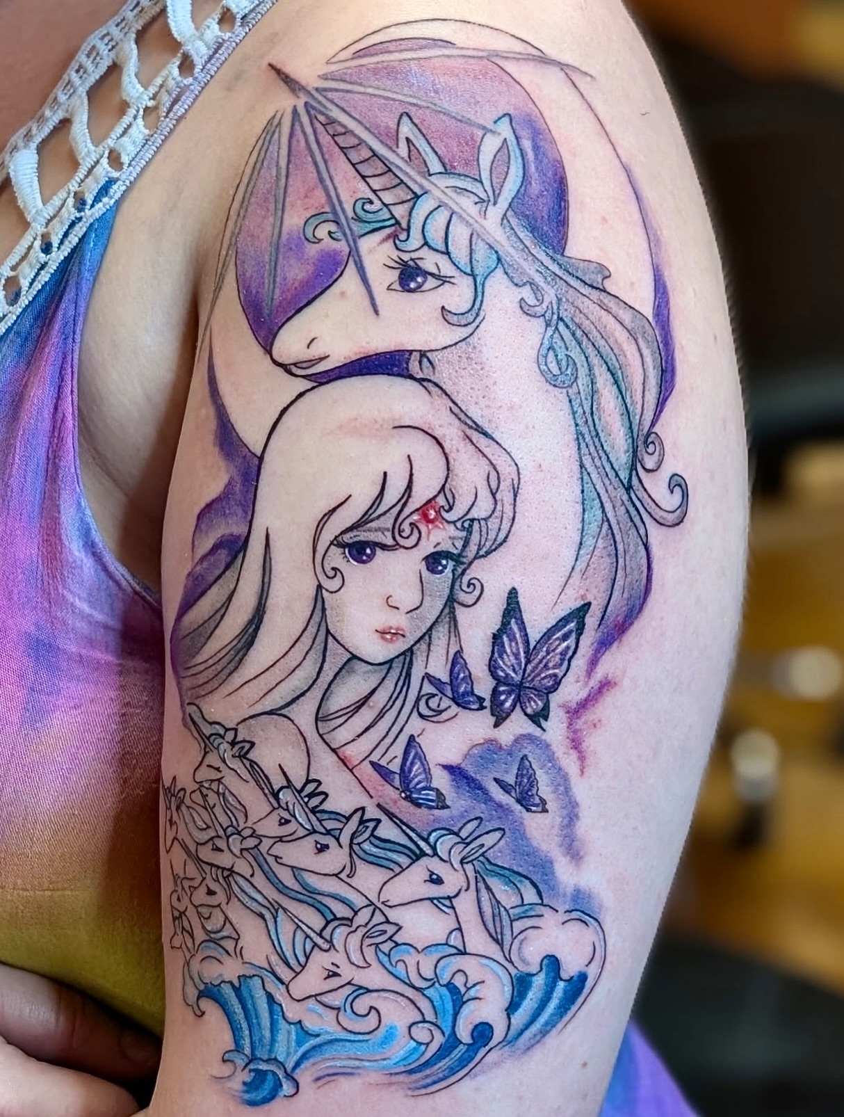Mermaid and unicorn watercolor tattoo on the shoulder by Kelly Von Tattoos, Saxapahaw, North Carolina