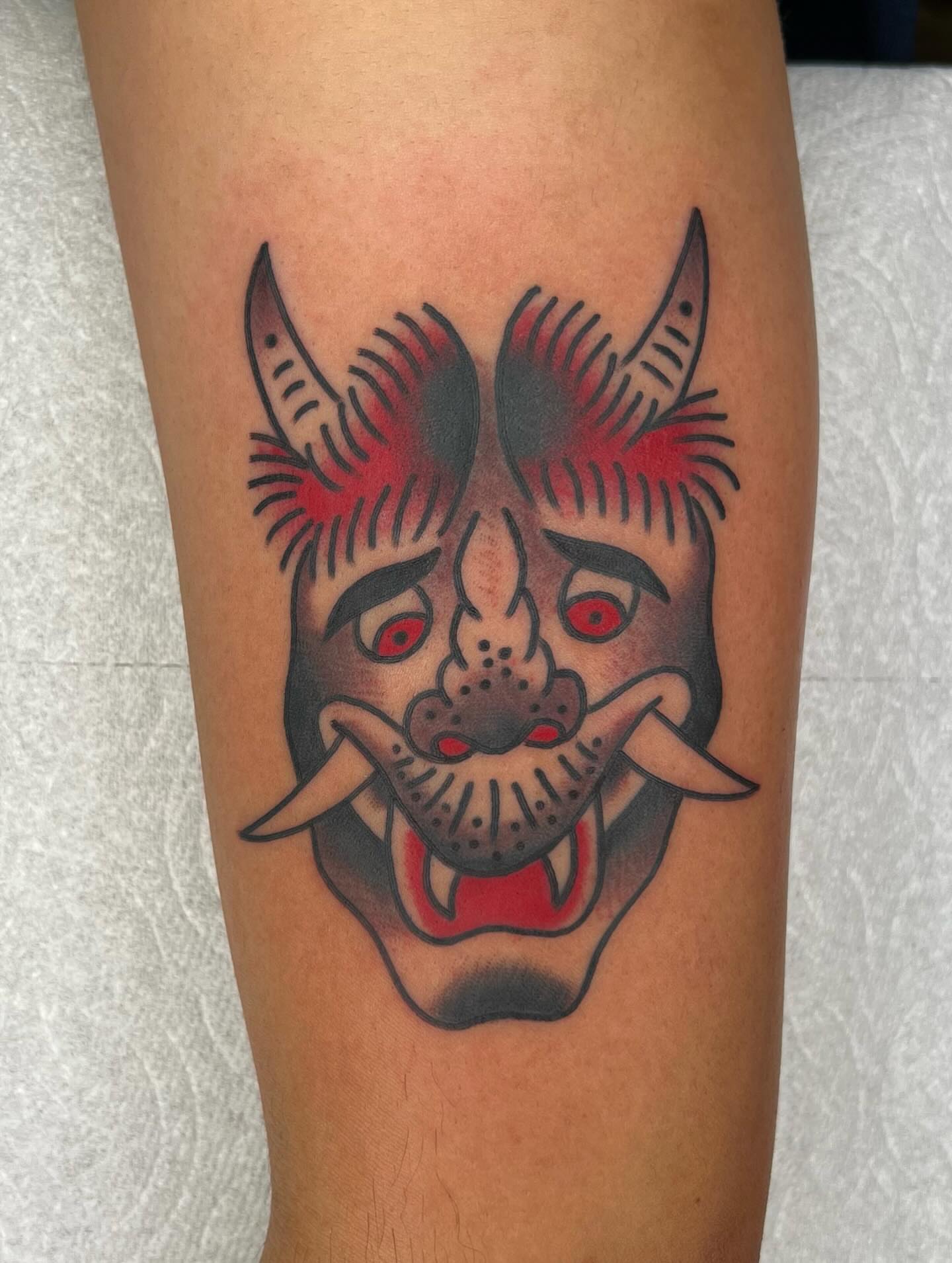 Demon mask American traditional tattoo on the forearm by Mikey Montoya