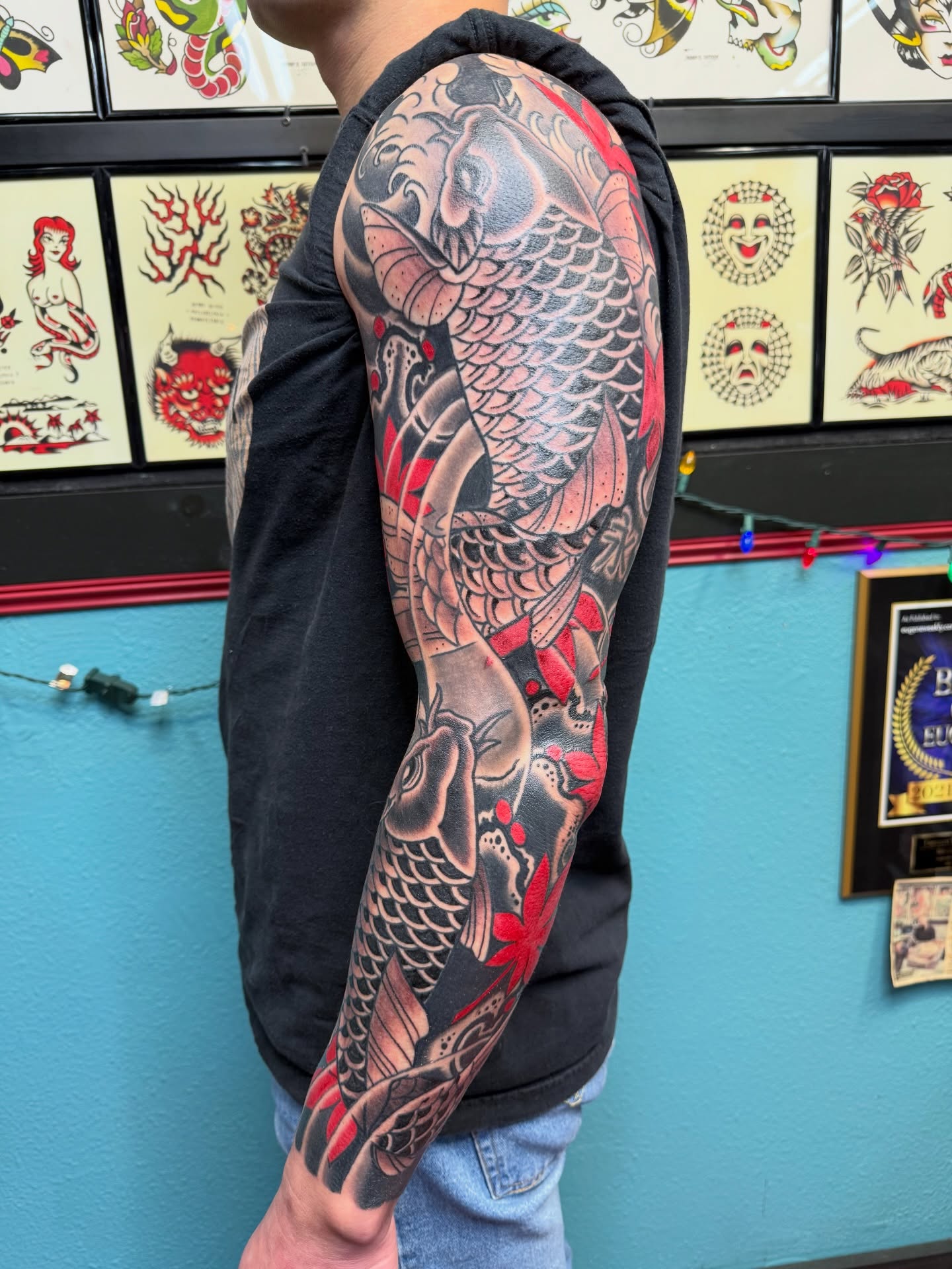 Koi fish American traditional tattoo on the upper arm by DemianThompson