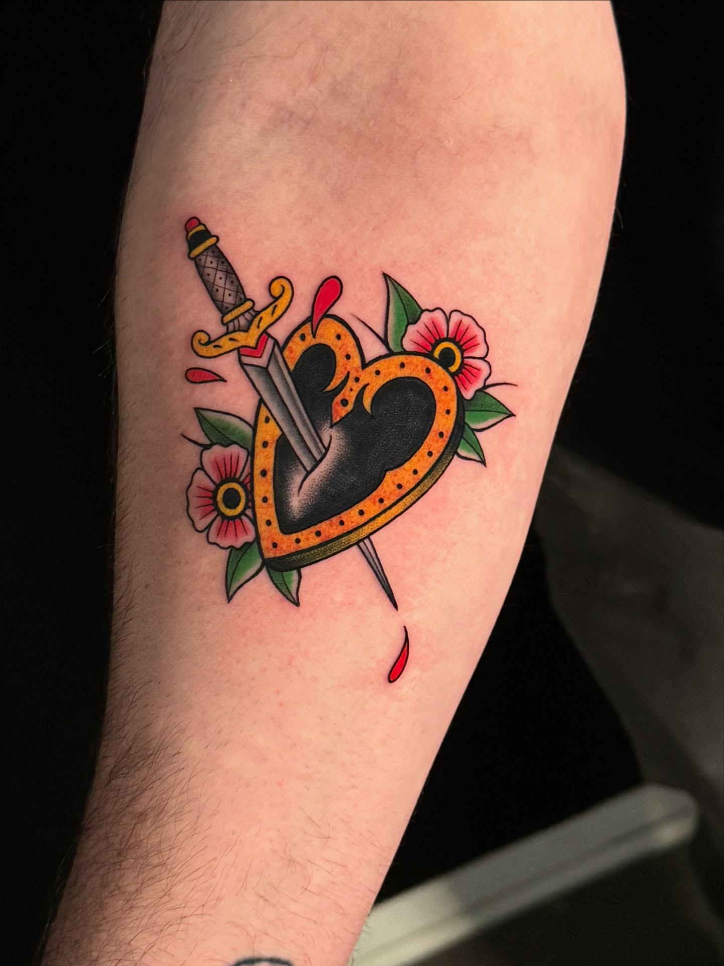 Heart with dagger American traditional tattoo on the forearm by HAiZiE