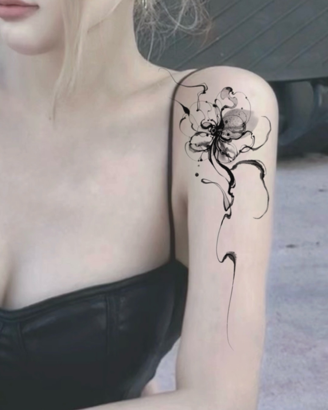 Flower black and grey tattoo on the upper arm by @tattoo_chamsae