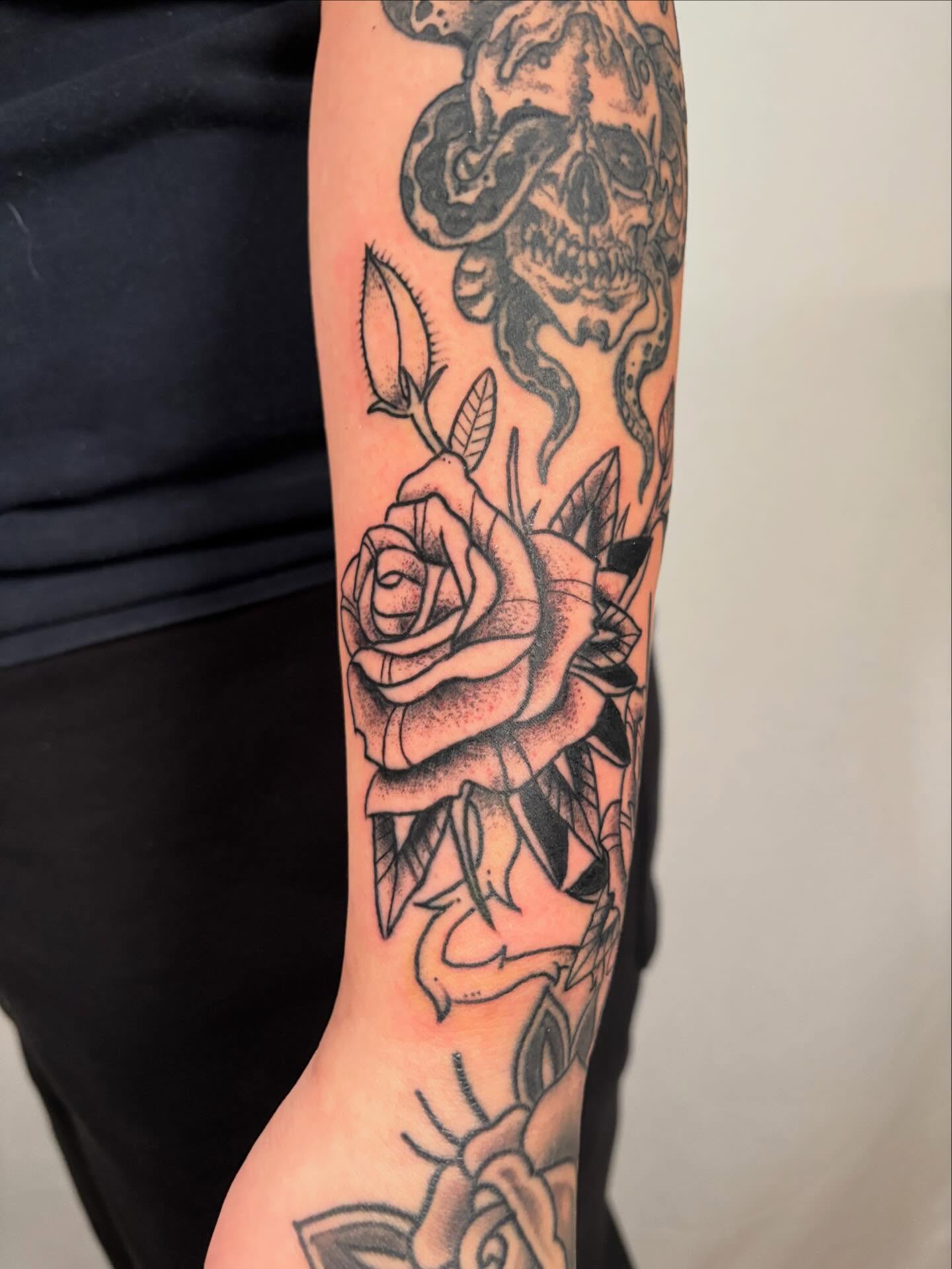 Rose and skull geometric tattoo on the forearm by Davie Tattoos
