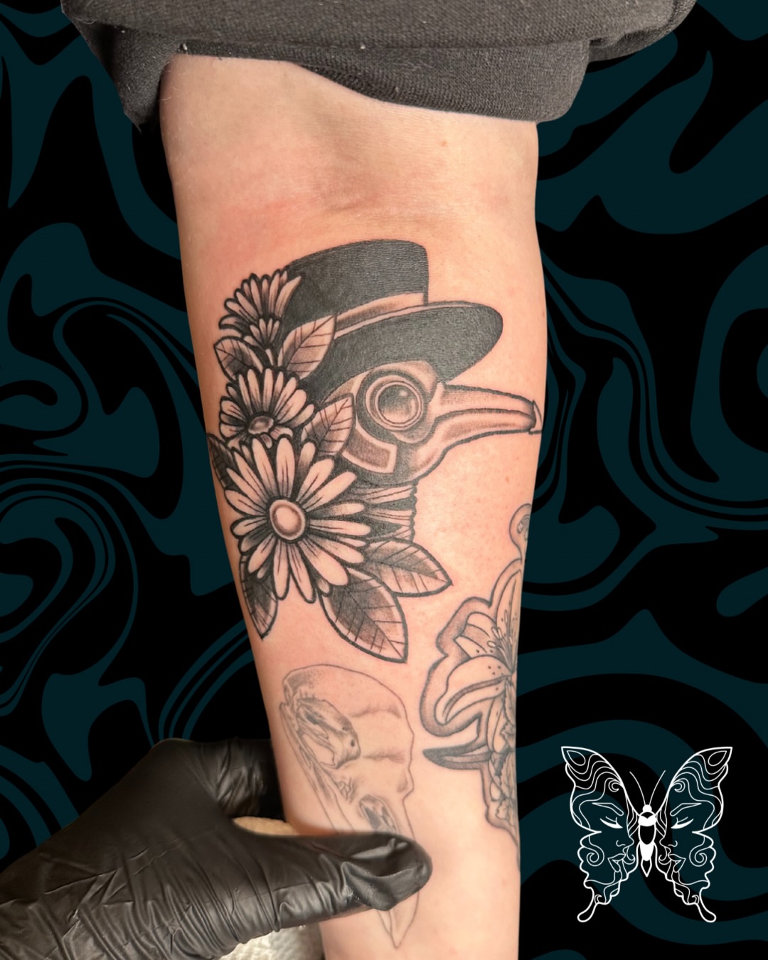 Plague doctor mask black and grey tattoo on the forearm by Nicci