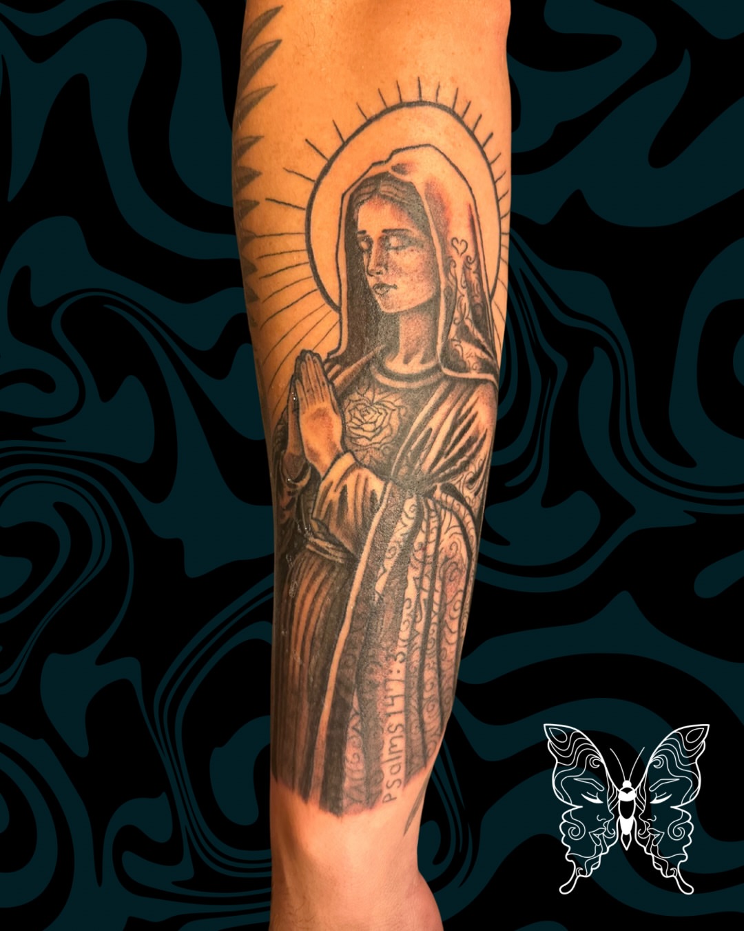 Religious figure black and grey tattoo on the forearm by Nicci