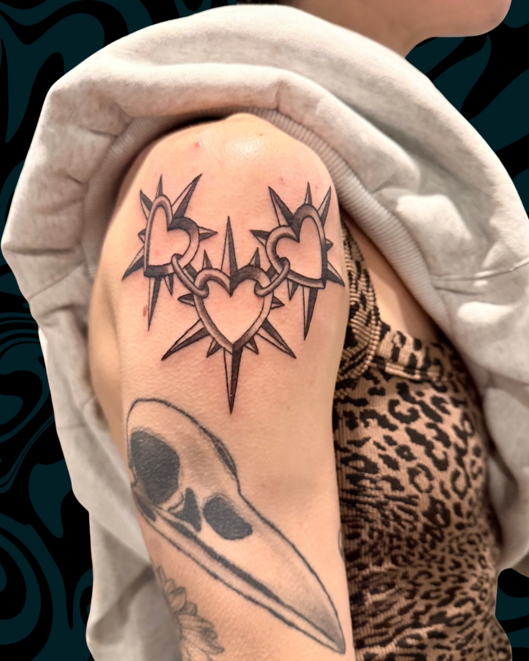 Heart and spikes black and grey tattoo on the shoulder by Nicci