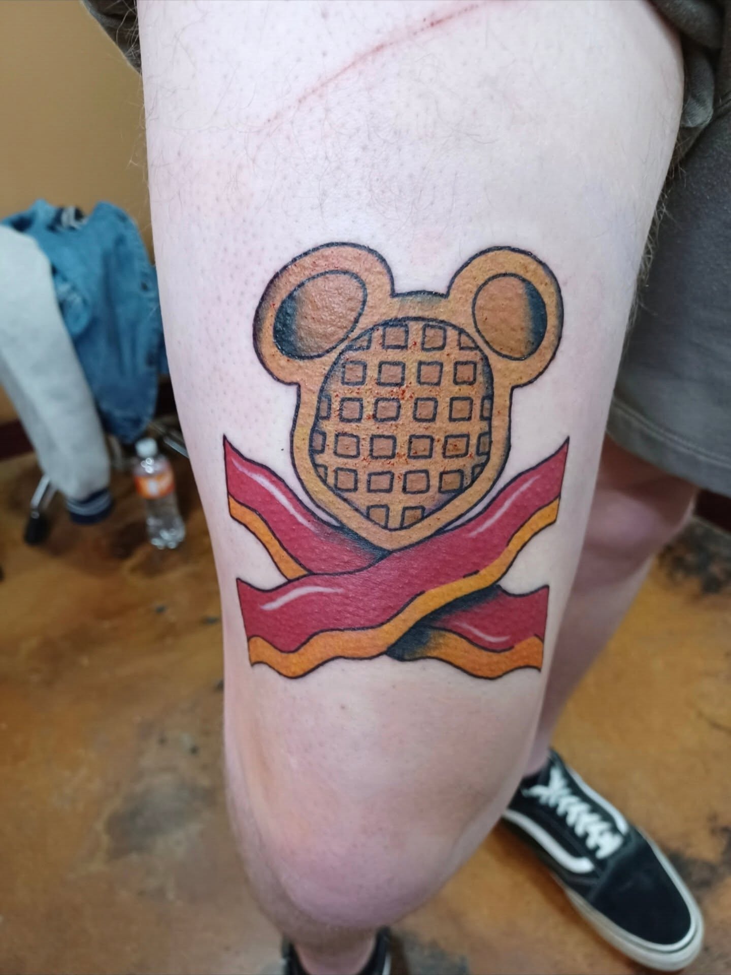 Waffle with ears trash polka tattoo on the thigh by Chris Bell