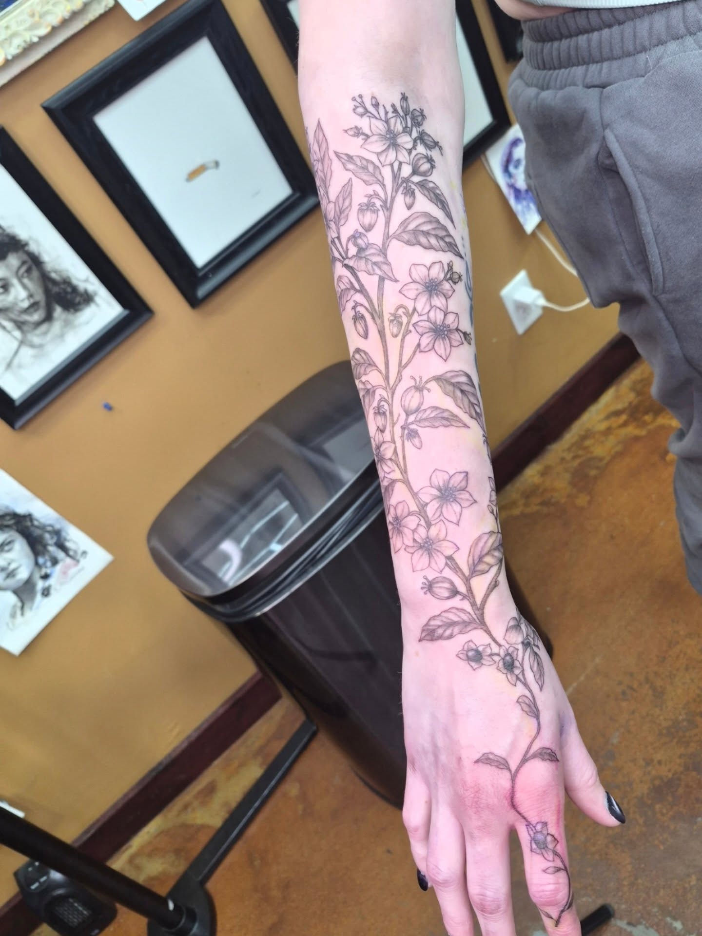 Flower vine black and grey tattoo on the forearm by Chris Bell