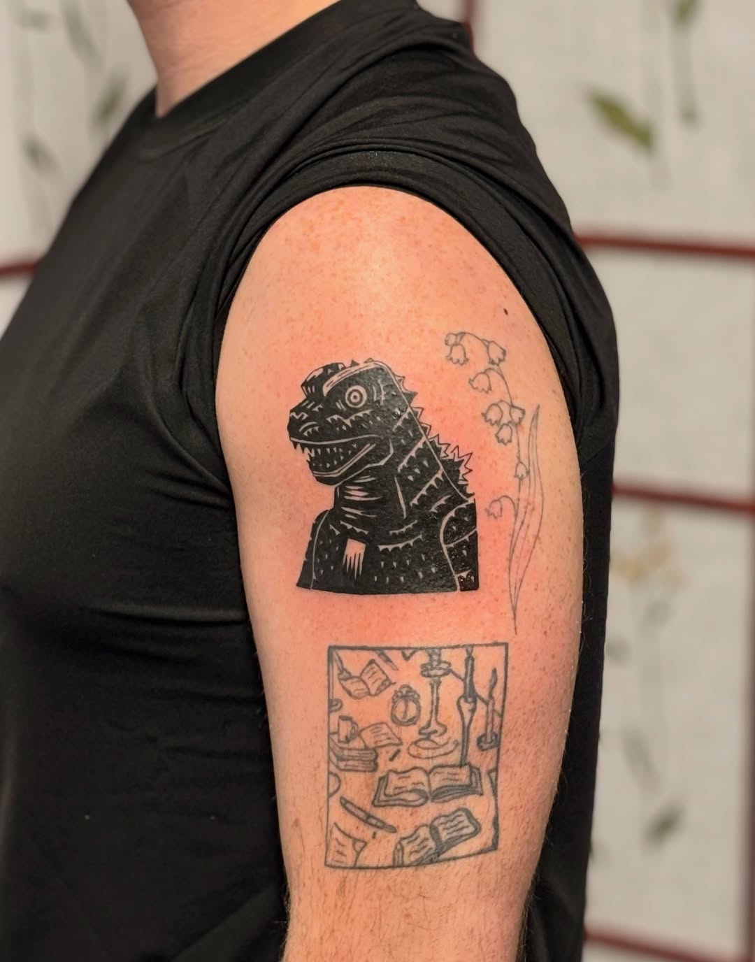 Godzilla and books anime tattoo on the forearm by CJ