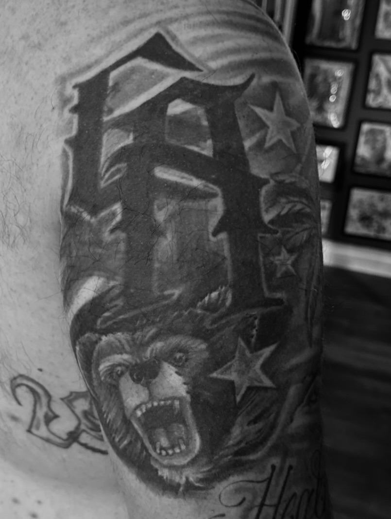 Bear black and grey tattoo on the forearm by Big Steve Lewis