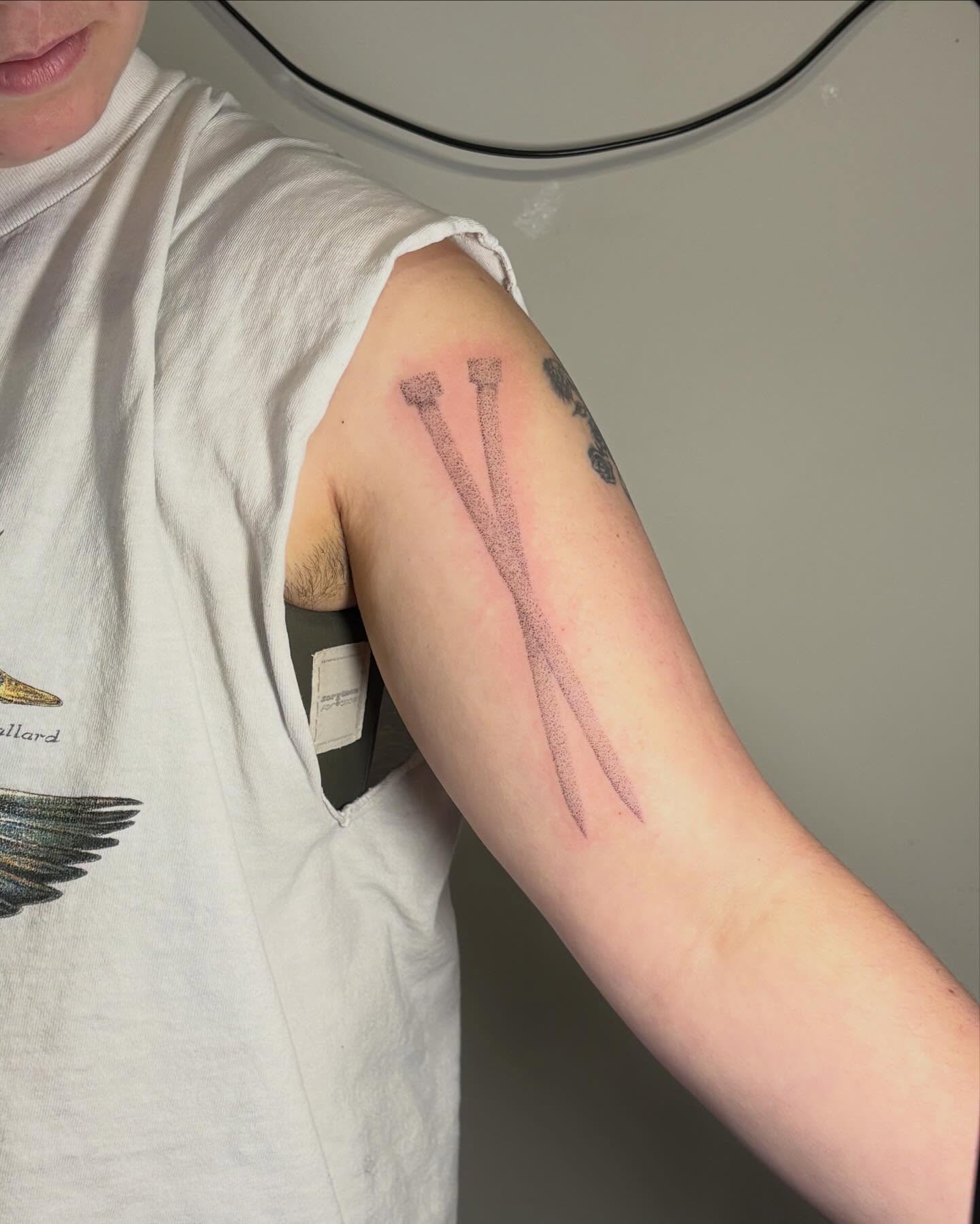 Crossbones black and grey tattoo on the forearm by Jill