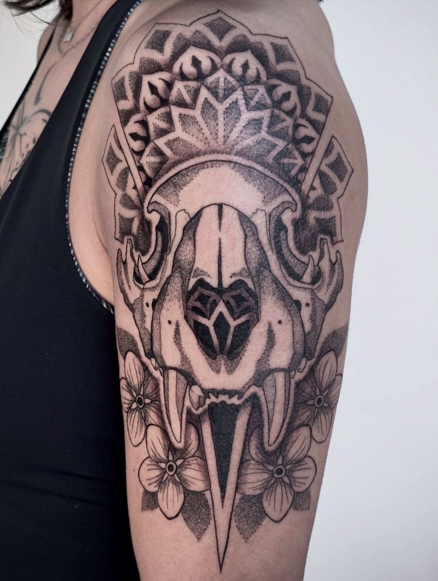 Skull and flowers dotwork tattoo on the forearm by Christine Hendricks, Denver, Colorado