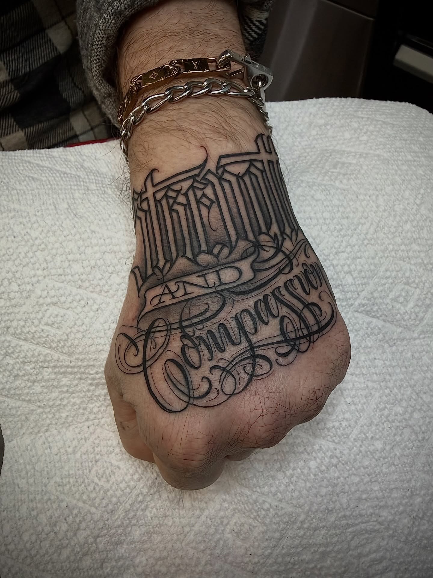 Crosses and script black and grey tattoo on the hand by $krypt