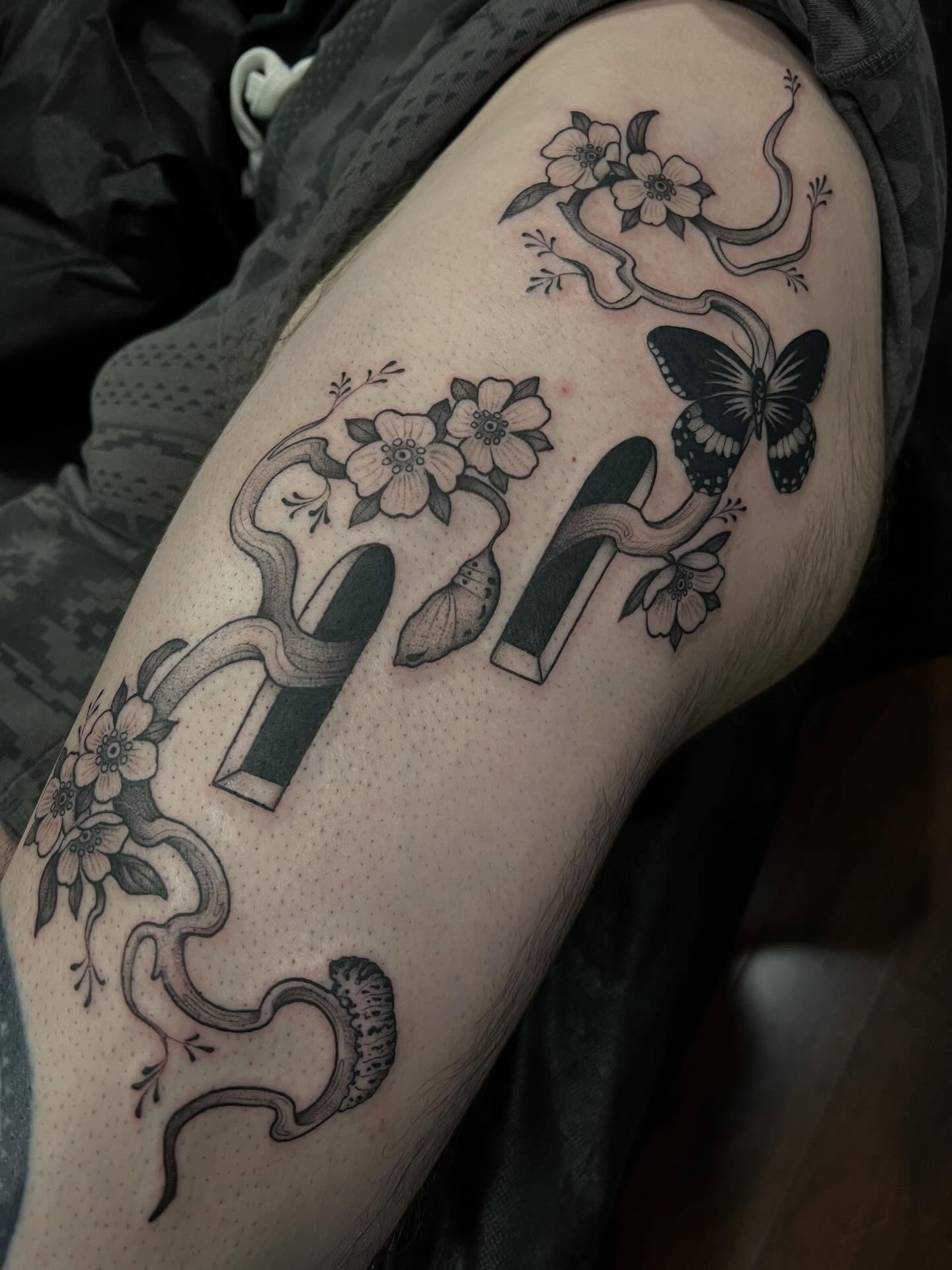 Snake and flowers dotwork tattoo on the thigh by Avrey Simone