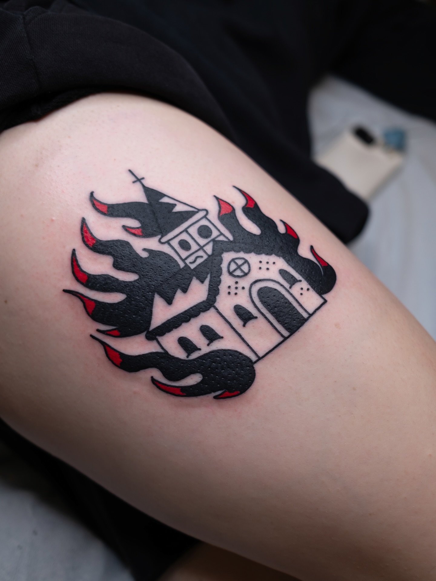 Castle with flames black and grey tattoo on the thigh by Neto Velasco - Sad Cat Tattoo, Austin, Texas