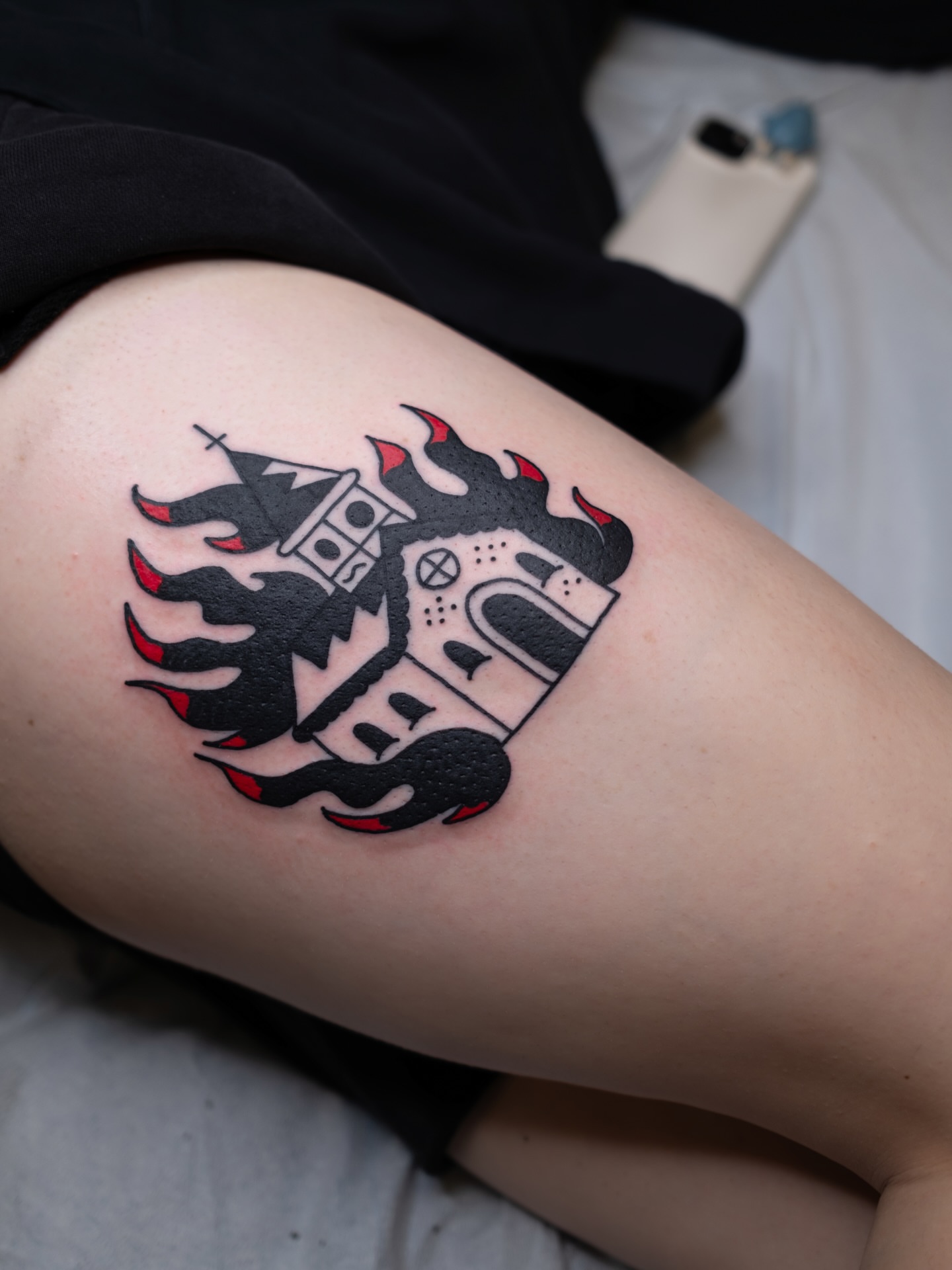 Burning castle black and grey tattoo on the thigh by Neto Velasco - Sad Cat Tattoo, Austin, Texas