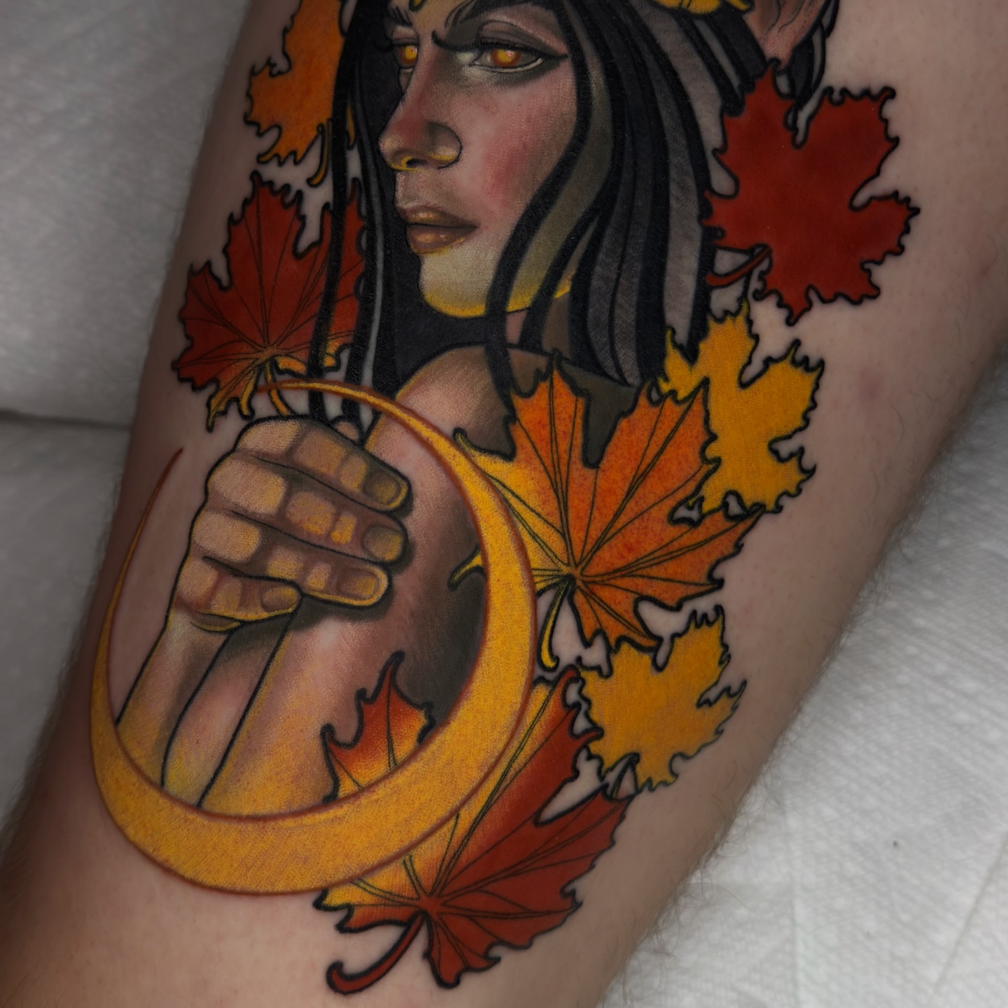 Autumn leaves and woman realism tattoo on the forearm by Golden Heart Tattoo Co