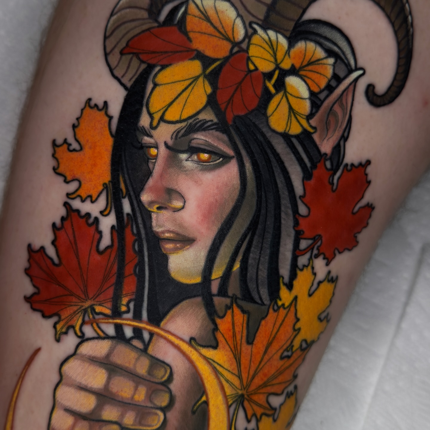 Autumnal figure American traditional tattoo on the forearm by Golden Heart Tattoo Co