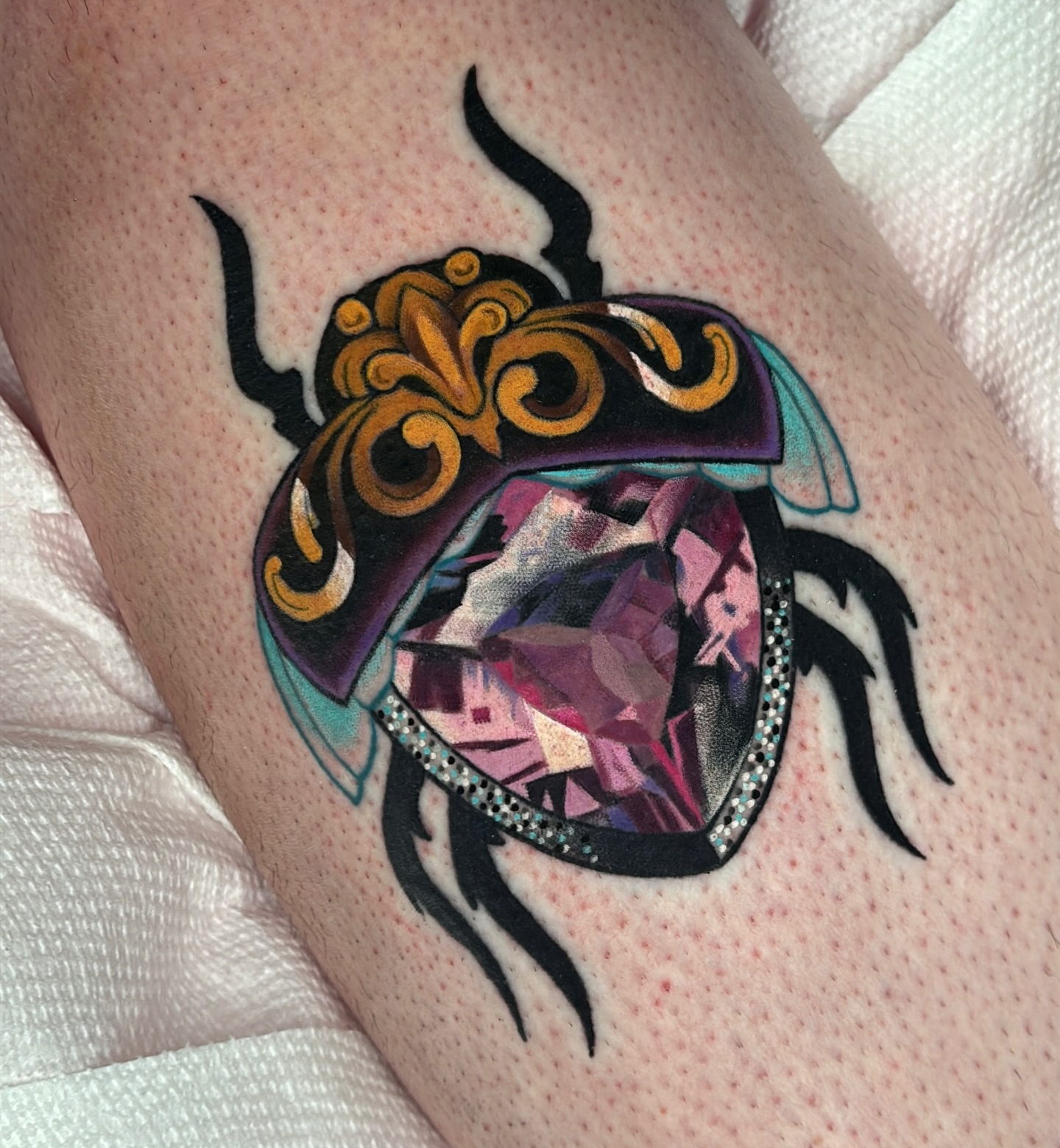 Beetle geometric tattoo on the thigh by Latesha Burnley